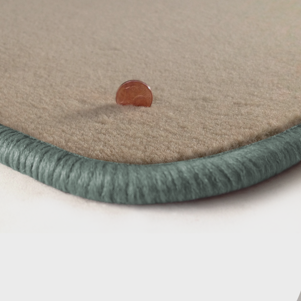 Eine Ecke als Beispiel einer Fussmatte Velours beige mit Rand in silbergrau.